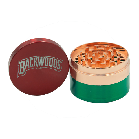 Backwoods metal grinder in red and green with copper-colored internal mechanism and Backwoods logo on the lid