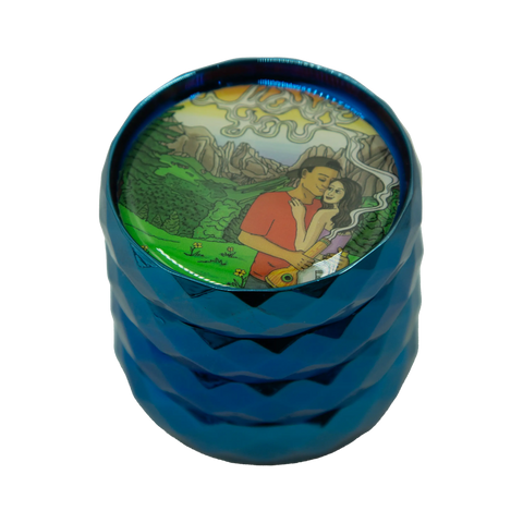 Blue metallic grinder with a colorful illustrated lid showing a couple in a mountainous landscape