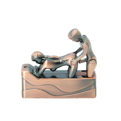 Shiny metallic erotic lighter featuring two stylized human figures in an intimate pose on a wavy rectangular base