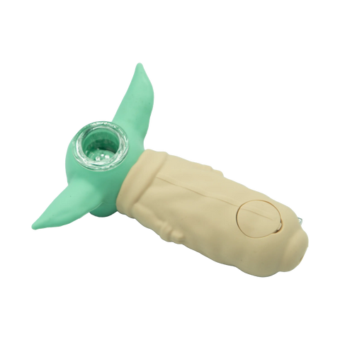A mint green and beige silicone hand pipe shaped like grogu from star wars with a clear glass bowl from the fun silicone hand pipe collection
