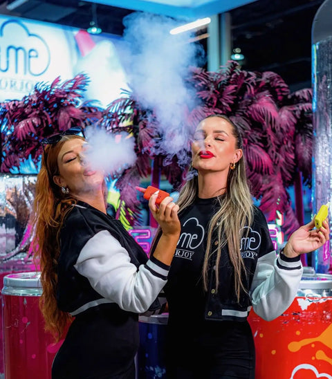 Orange vape pen held in a woman’s hand