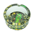 Clear glass rick and morty ashtray featuring a green pickle character with guns on a black and yellow camo pattern