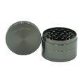 Silver metallic four-piece SharpStone classic metal herb grinder with brushed finish and engraved brand name on lid