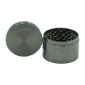 Silver metallic four-piece metal herb grinder with brushed finish and sharpstone logo engraved on lid