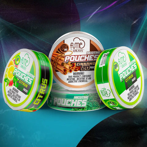 Three circular, metallic tin containers of fme by orjoy nicotine pouches in citrus and cinnamon flavors.