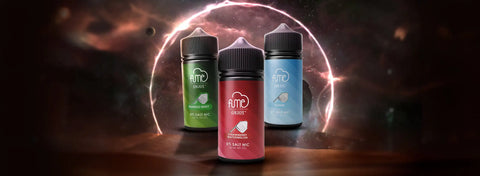 Three fume brand e-liquid bottles, each with a black cap and distinct color-coded labels, green for “mint,” red for “strawberry,” and blue for “blue”, displayed against a cosmic backdrop.