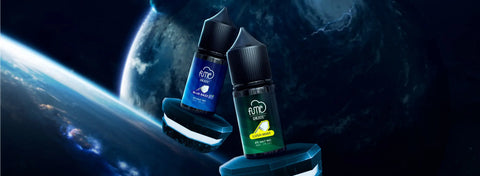 Two sleek, transparent glass bottles with black caps and labels, blue for ’blue raspberry’ and green for ’lemon mint’, displayed against a cosmic backdrop.