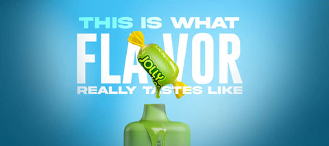 A vibrant green jolly rancher candy wrapper with yellow foil ends, featuring the brand name in bold black lettering.